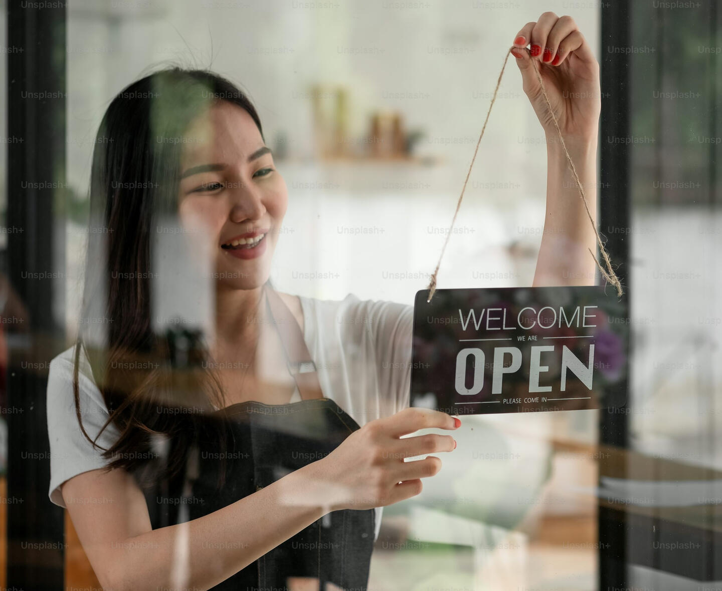 Small shop owner hanging open sign for FeedbackBuddy app.
